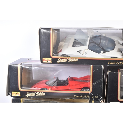 374 - A large collection of assorted 1/18 scale boxed diecast model cars by Maisto, Burago and Welly. Exam... 