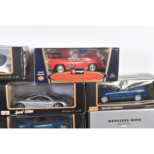 374 - A large collection of assorted 1/18 scale boxed diecast model cars by Maisto, Burago and Welly. Exam... 