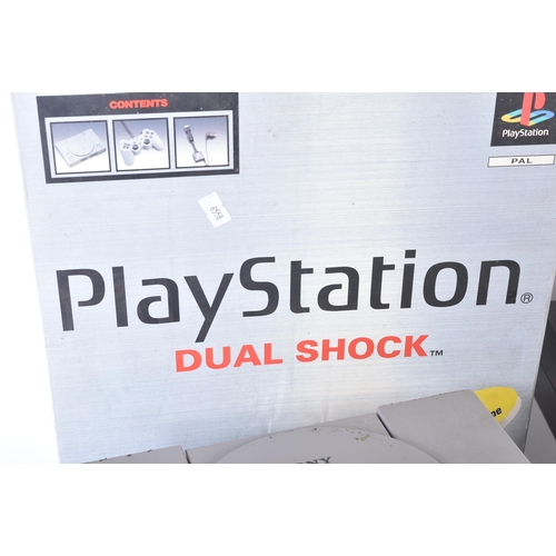 385 - Retro Gaming - a vintage PS Playstation video game console bundle comprising x4 original Playstation... 