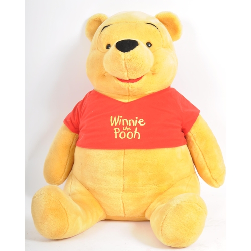 471 - A gigantic Winnie the Pooh teddy bear / plush toy, sporting his customary red t-shirt. Measures appr... 