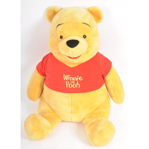 471 - A gigantic Winnie the Pooh teddy bear / plush toy, sporting his customary red t-shirt. Measures appr... 