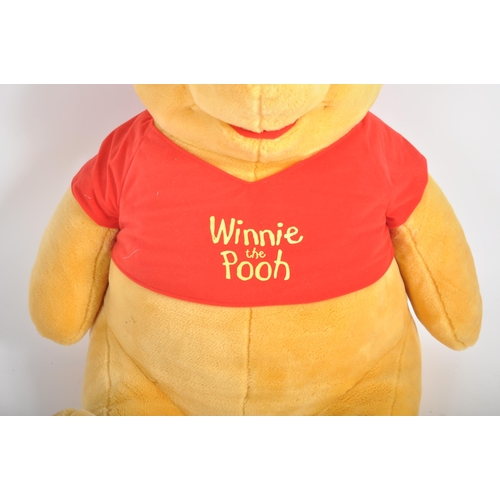 471 - A gigantic Winnie the Pooh teddy bear / plush toy, sporting his customary red t-shirt. Measures appr... 