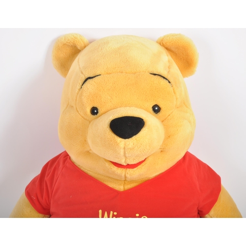 471 - A gigantic Winnie the Pooh teddy bear / plush toy, sporting his customary red t-shirt. Measures appr... 