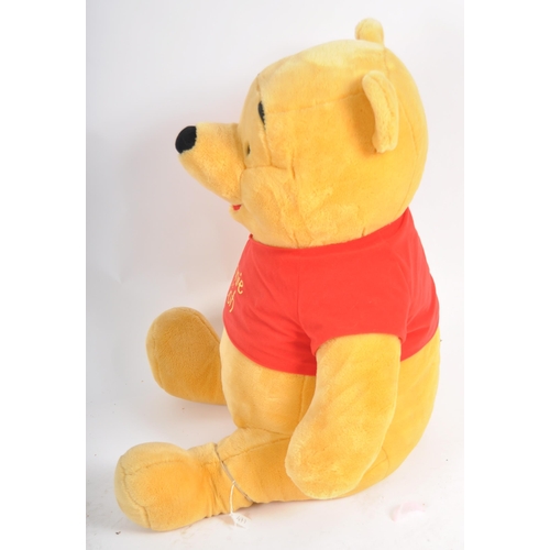 471 - A gigantic Winnie the Pooh teddy bear / plush toy, sporting his customary red t-shirt. Measures appr... 