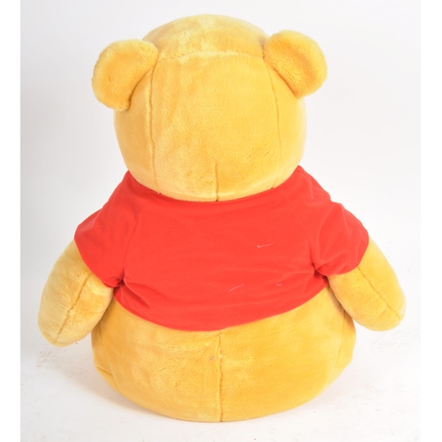 471 - A gigantic Winnie the Pooh teddy bear / plush toy, sporting his customary red t-shirt. Measures appr... 