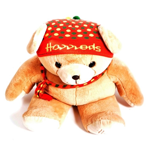 27 - A gigantic Harrods shop display Teddy Bear, sporting a labelled Harrods polkadot beanie hat and scar... 