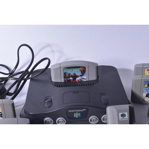 615 - Retro Gaming - a vintage N64 Nintendo 64 video game console with a selection of games and rumble pak... 