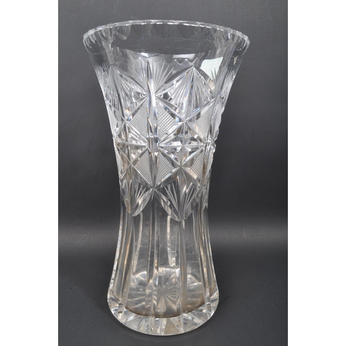 33 - A collection of four 20th century large cut glass crystal vases to include thistle shaped vase along... 