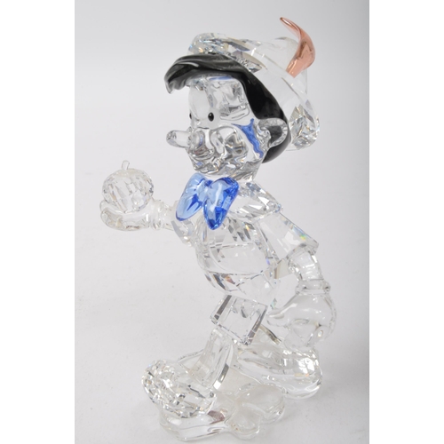 35 - Swarovski - Pinocchio - A vintage 20th century Swarovski glass boxed Pinocchio figurine depicted wea... 