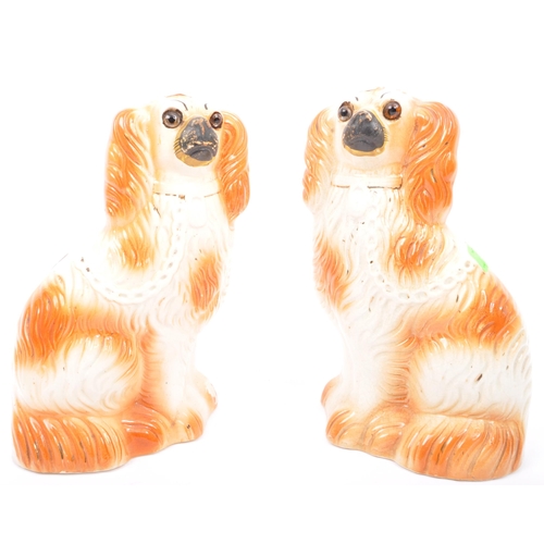 39 - A pair of Victorian 19th century English Staffordshire ceramic dogs in seated position.