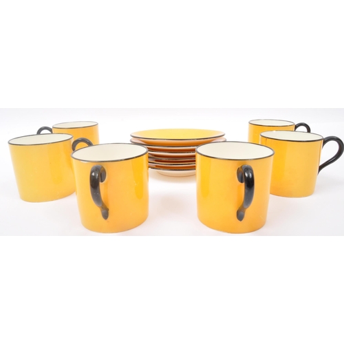 43 - A mid 20th Century Heal & Sons two tone coffee tea service. Having a yellow ground with a ebonised r... 