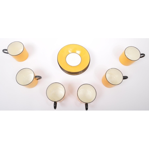 43 - A mid 20th Century Heal & Sons two tone coffee tea service. Having a yellow ground with a ebonised r... 