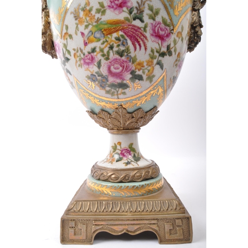 59 - A large 19th century Victorian style ceramic and gilded metal twin handled urn vase. The vase having... 