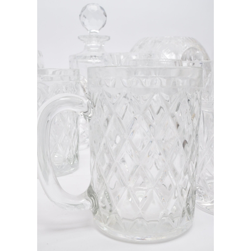 79 - A large collection of vintage 20th century cut glass items. The lot to include decanters, an oversiz... 