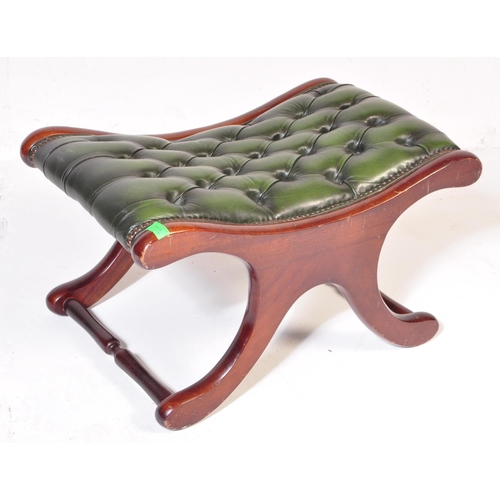 1008 - A 20th century leather button back Chesterfield sofa footstool ottoman having green button back leat... 