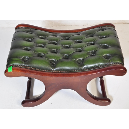 1008 - A 20th century leather button back Chesterfield sofa footstool ottoman having green button back leat... 