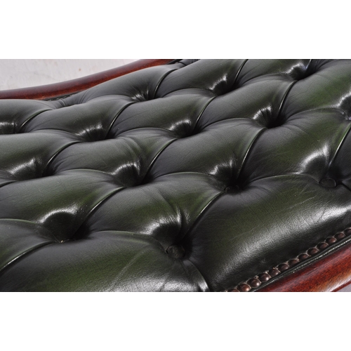 1008 - A 20th century leather button back Chesterfield sofa footstool ottoman having green button back leat... 