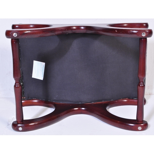 1008 - A 20th century leather button back Chesterfield sofa footstool ottoman having green button back leat... 