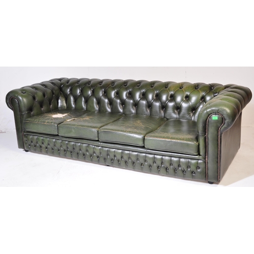 1009 - A 20th century four setter leather button back Chesterfield sofa settee. Raised on bun feet with gre... 