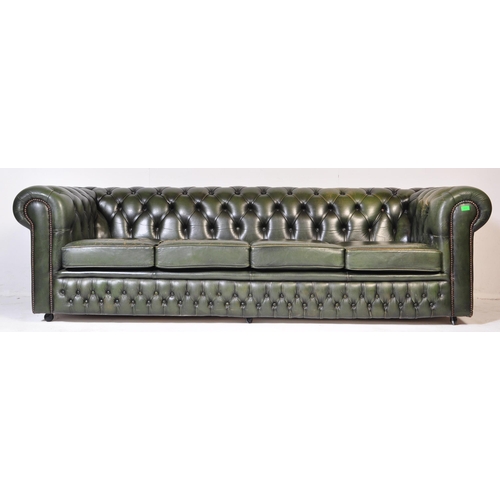 1009 - A 20th century four setter leather button back Chesterfield sofa settee. Raised on bun feet with gre... 