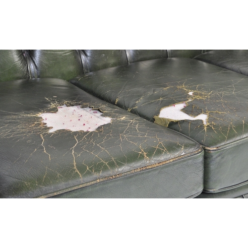 1009 - A 20th century four setter leather button back Chesterfield sofa settee. Raised on bun feet with gre... 