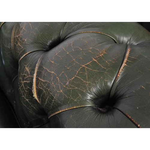 1009 - A 20th century four setter leather button back Chesterfield sofa settee. Raised on bun feet with gre... 
