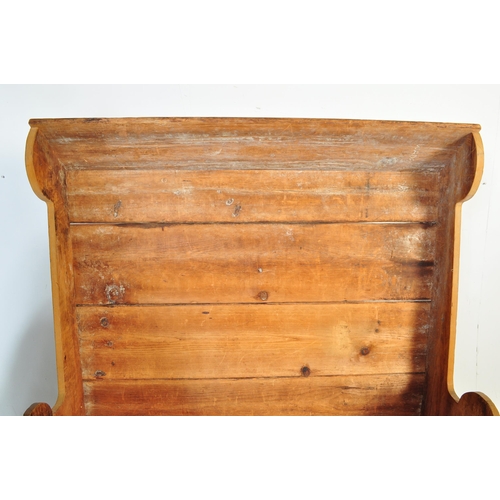1010 - A 19th Century Victorian pine tavern settle bench pew. Having a canopy top over a panelled back flan... 