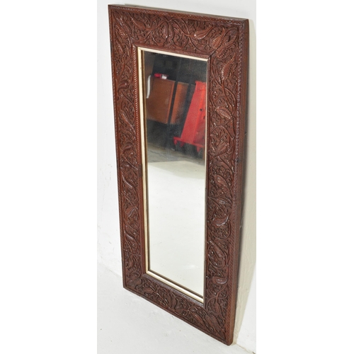 1012 - Early 20th century carved hardwood Asiatic wall mirror. Of rectangular form having carved relief wor... 