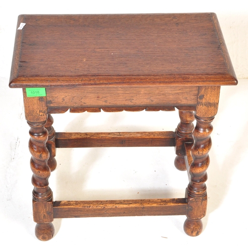 1018 - Jacobean revival peg jointed oak stool. Raised on barley  twist legs with bell feet united by square... 