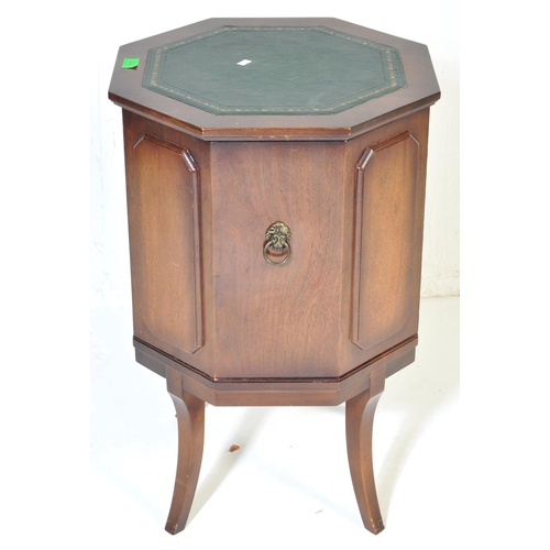 1019 - A Regency revival mahogany and gilt tooled leather  octagonal drum cabinet. Raised on sabre legs wit... 