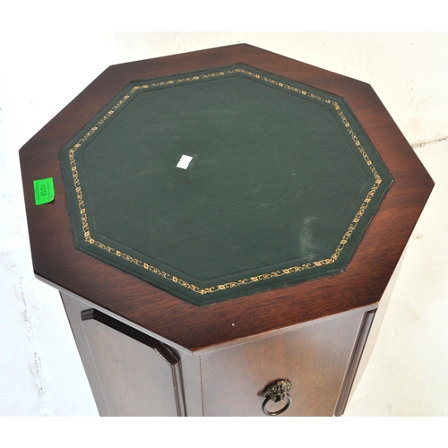 1019 - A Regency revival mahogany and gilt tooled leather  octagonal drum cabinet. Raised on sabre legs wit... 