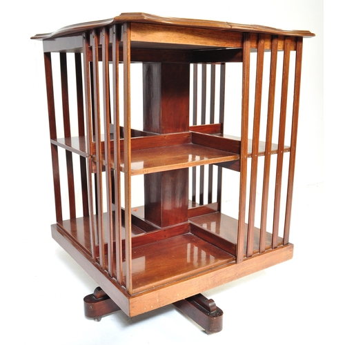 1022 - A Victorian 19th century mahogany revolving library bookcase. Raised on a four point base with uprig... 