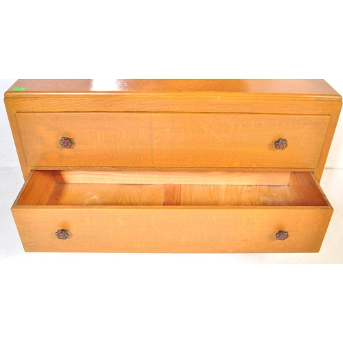 1033 - A vintage 20th Century Art Deco oak dressing chest of drawers with shaped mirror. Rectangular form w... 