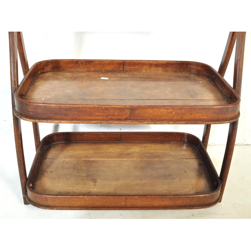 1045 - A 19th Century mahogany wood two tier butlers tray. Having a bar lifting support to top, with curved... 