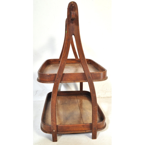 1045 - A 19th Century mahogany wood two tier butlers tray. Having a bar lifting support to top, with curved... 