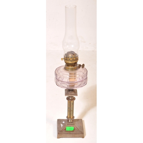 1047 - A 19th Century brass and metal oil lamp light. With glass flute shade to top, clear purple reservoir... 