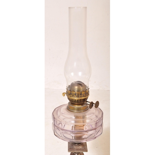 1047 - A 19th Century brass and metal oil lamp light. With glass flute shade to top, clear purple reservoir... 