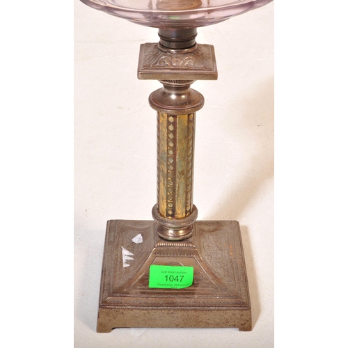 1047 - A 19th Century brass and metal oil lamp light. With glass flute shade to top, clear purple reservoir... 