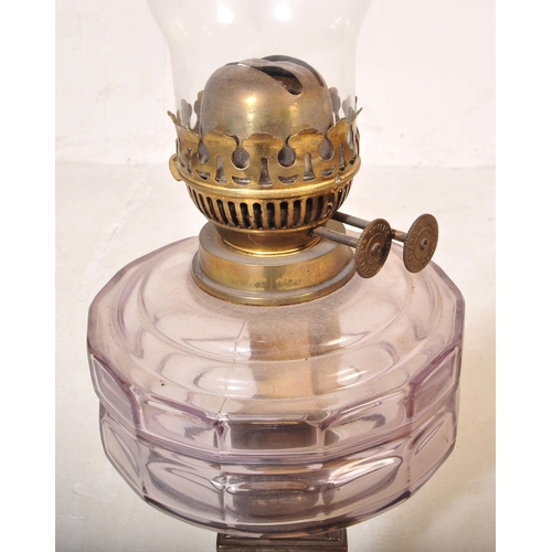 1047 - A 19th Century brass and metal oil lamp light. With glass flute shade to top, clear purple reservoir... 