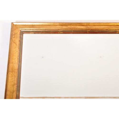 1048 - A large early 20th Century gilt over mantel mirror. Of rectangular form with gilt wood with bevelled... 