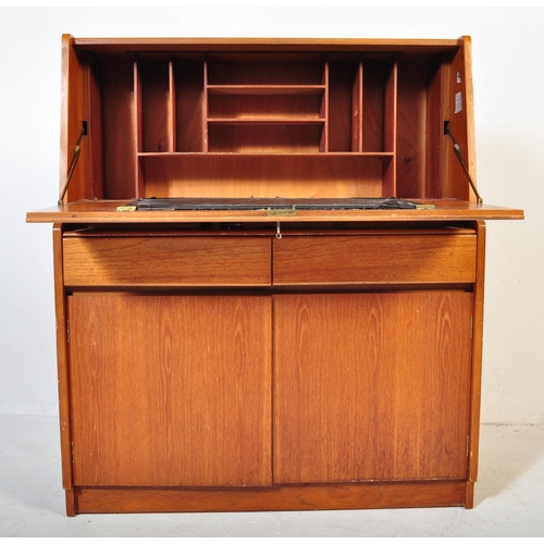 554 - A retro mid 20th century circa. 1960's teak bureau having a fall front cupboard door over fully appo... 