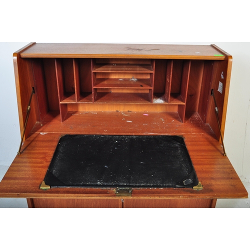 554 - A retro mid 20th century circa. 1960's teak bureau having a fall front cupboard door over fully appo... 