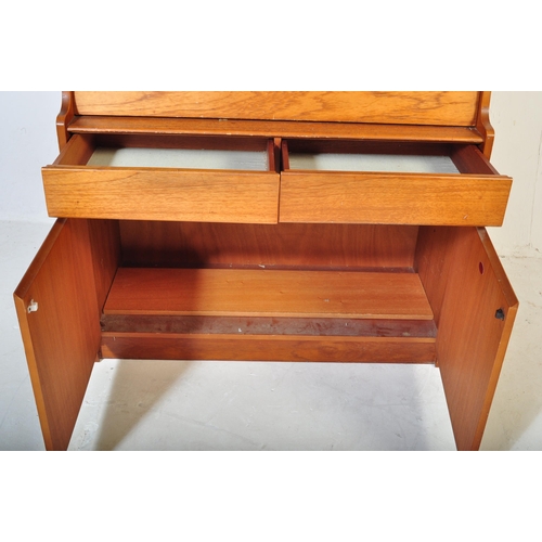 554 - A retro mid 20th century circa. 1960's teak bureau having a fall front cupboard door over fully appo... 