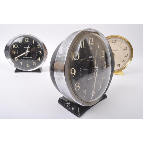 555 - A collection of three vintage mid 20th century clocks to include a Superbell accompanied by two West... 