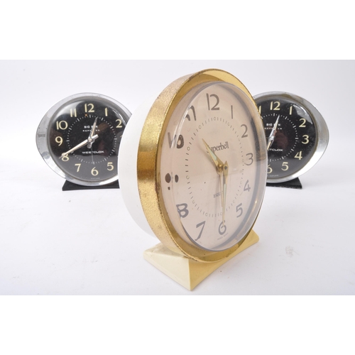 555 - A collection of three vintage mid 20th century clocks to include a Superbell accompanied by two West... 