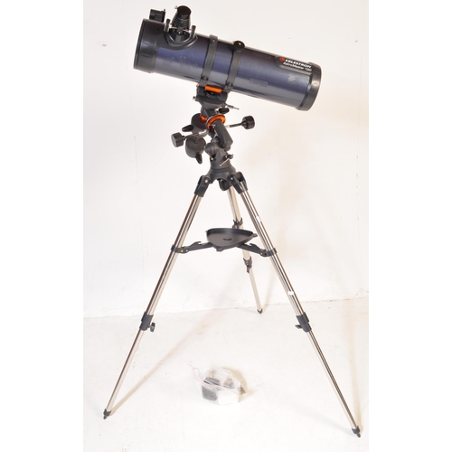 558 - A Celestron AstroMaster 130 telescope on tripod stand together with accessories & motors. Box not in... 