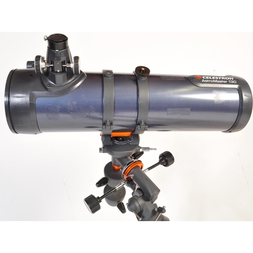 558 - A Celestron AstroMaster 130 telescope on tripod stand together with accessories & motors. Box not in... 