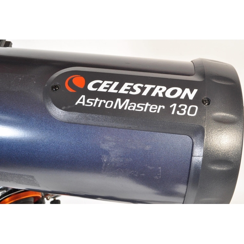 558 - A Celestron AstroMaster 130 telescope on tripod stand together with accessories & motors. Box not in... 