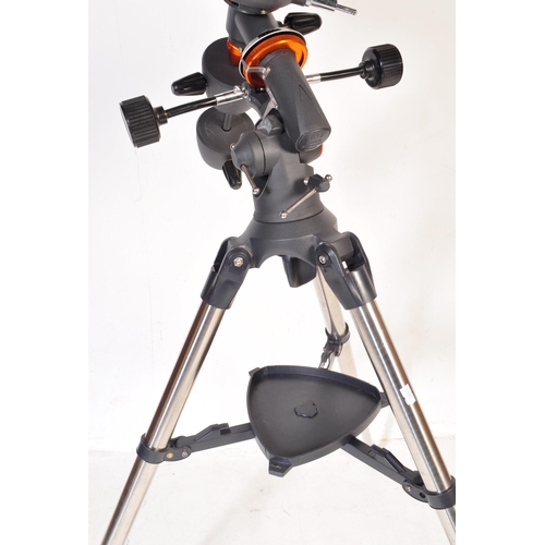 558 - A Celestron AstroMaster 130 telescope on tripod stand together with accessories & motors. Box not in... 