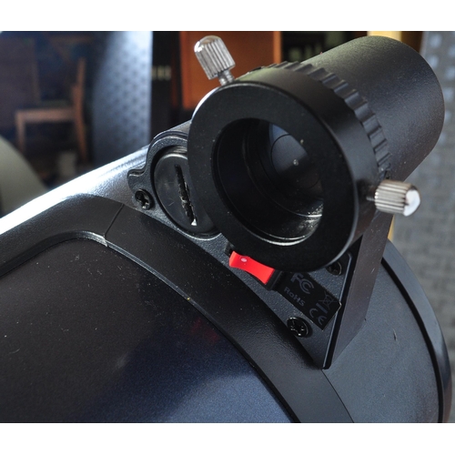 558 - A Celestron AstroMaster 130 telescope on tripod stand together with accessories & motors. Box not in... 